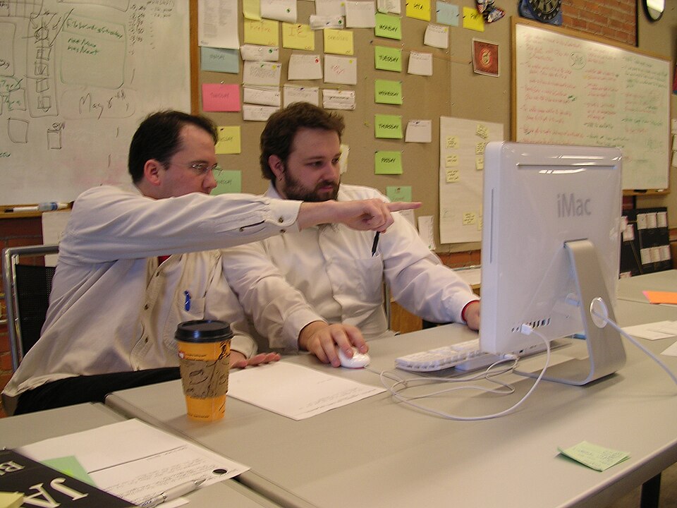 Two programmers pairing at one keyboard